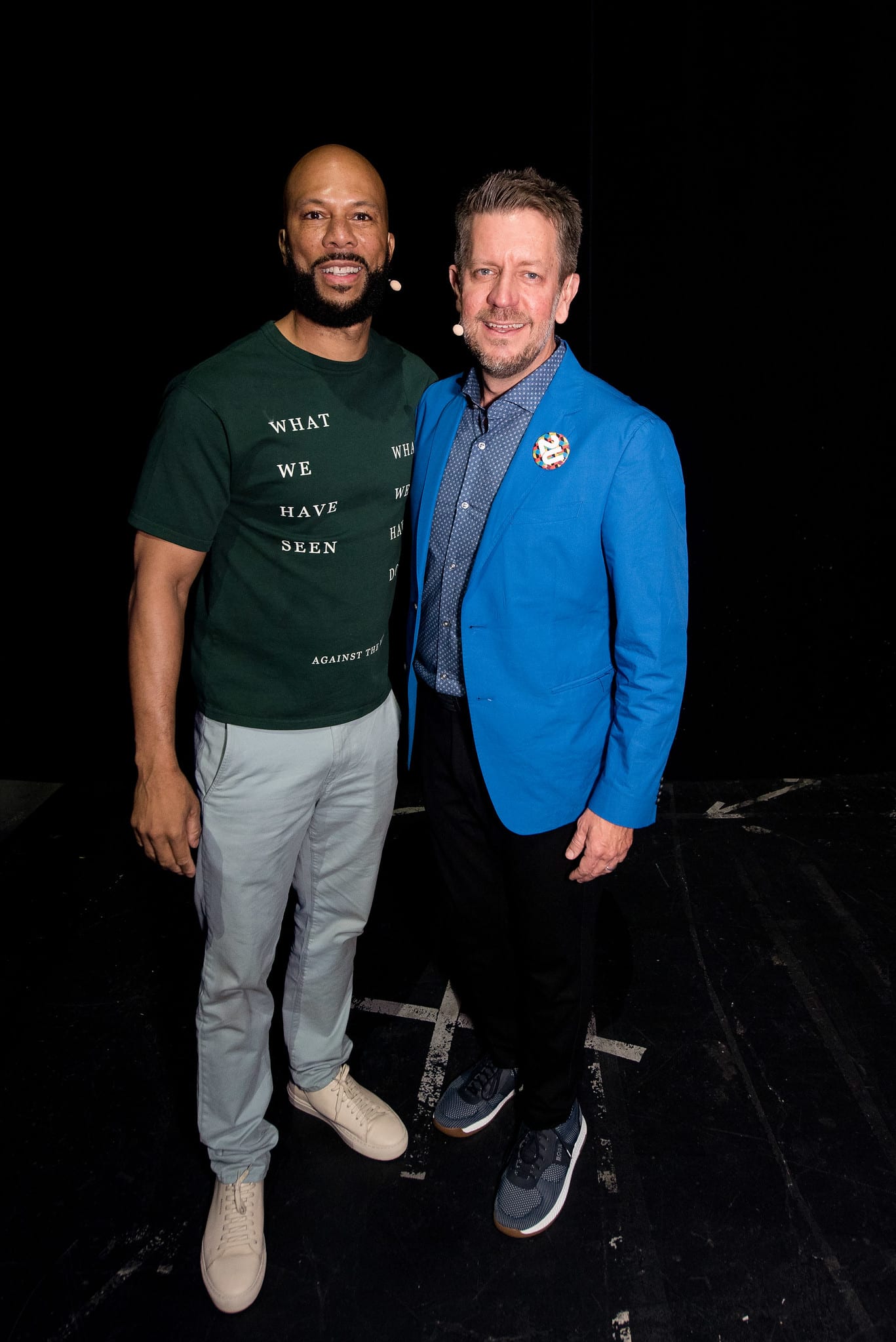 Common and Chip Paucek photographed side by side backstage in front of a black curtain