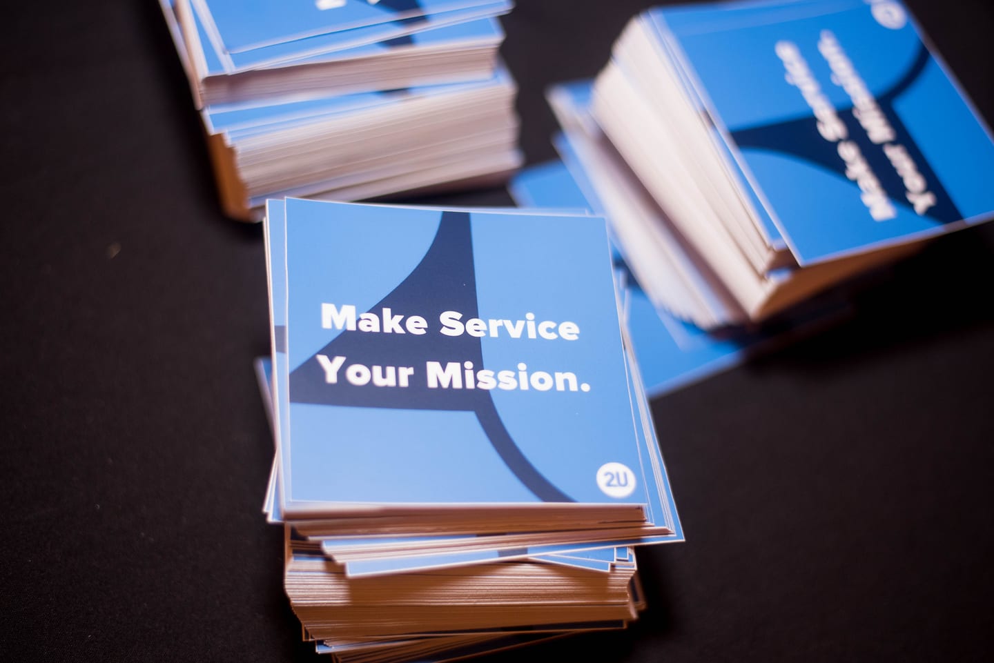 Stacked booklets printed Make Service Your Mission with the 2U logo