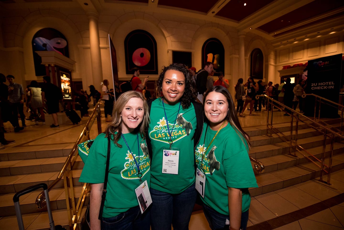 Three employees in green Las Vegas SOUL t-shirts in the Colosseum lobby