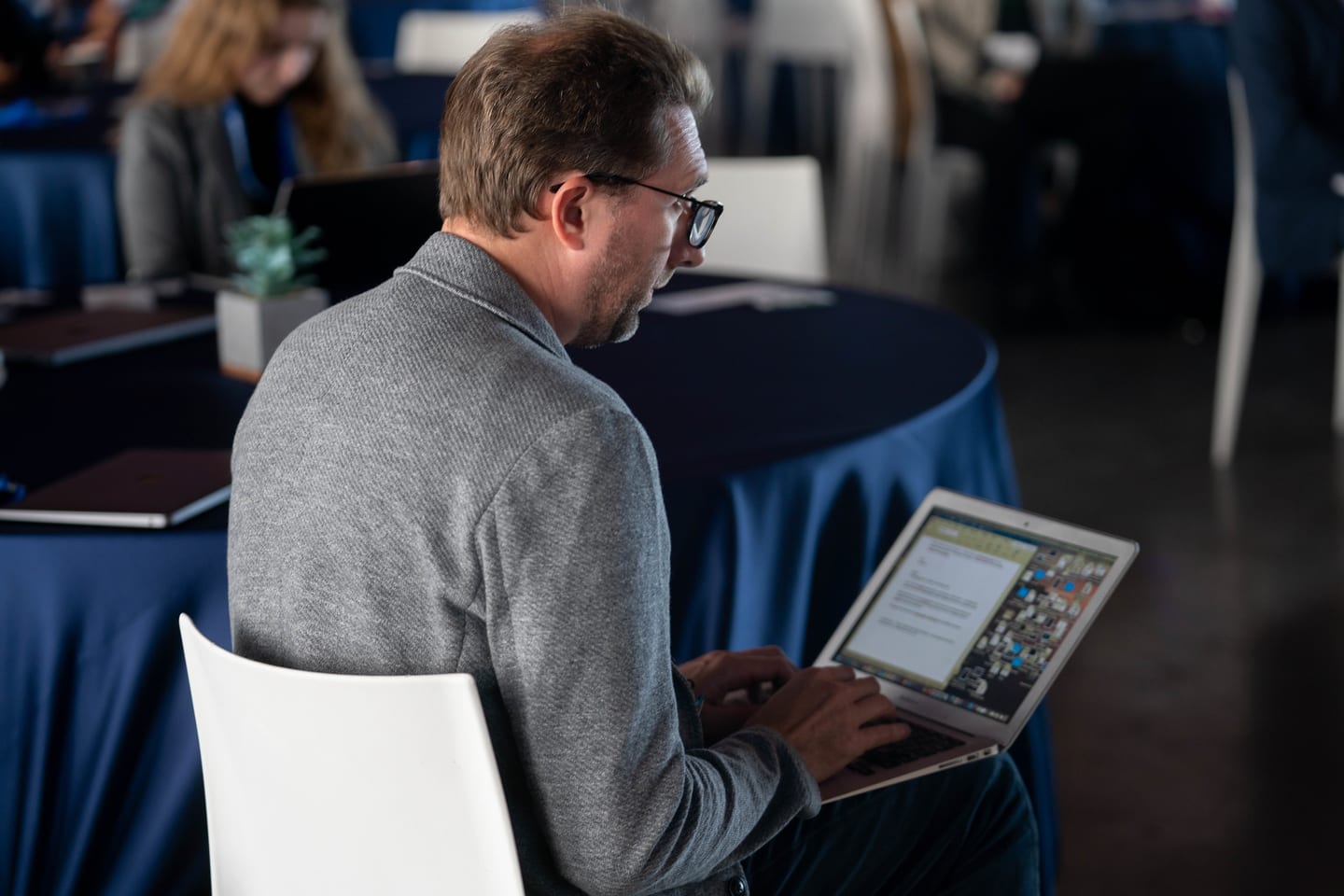 An attendee working at a table during the program at the Automotive News Congress: Los Angeles, City Market Social House