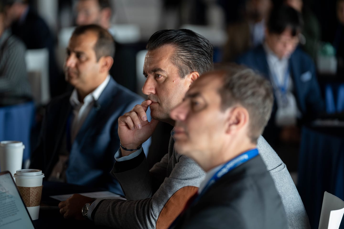 A close view of three attendees listening from the audience at the Automotive News Congress: Los Angeles, City Market Social House