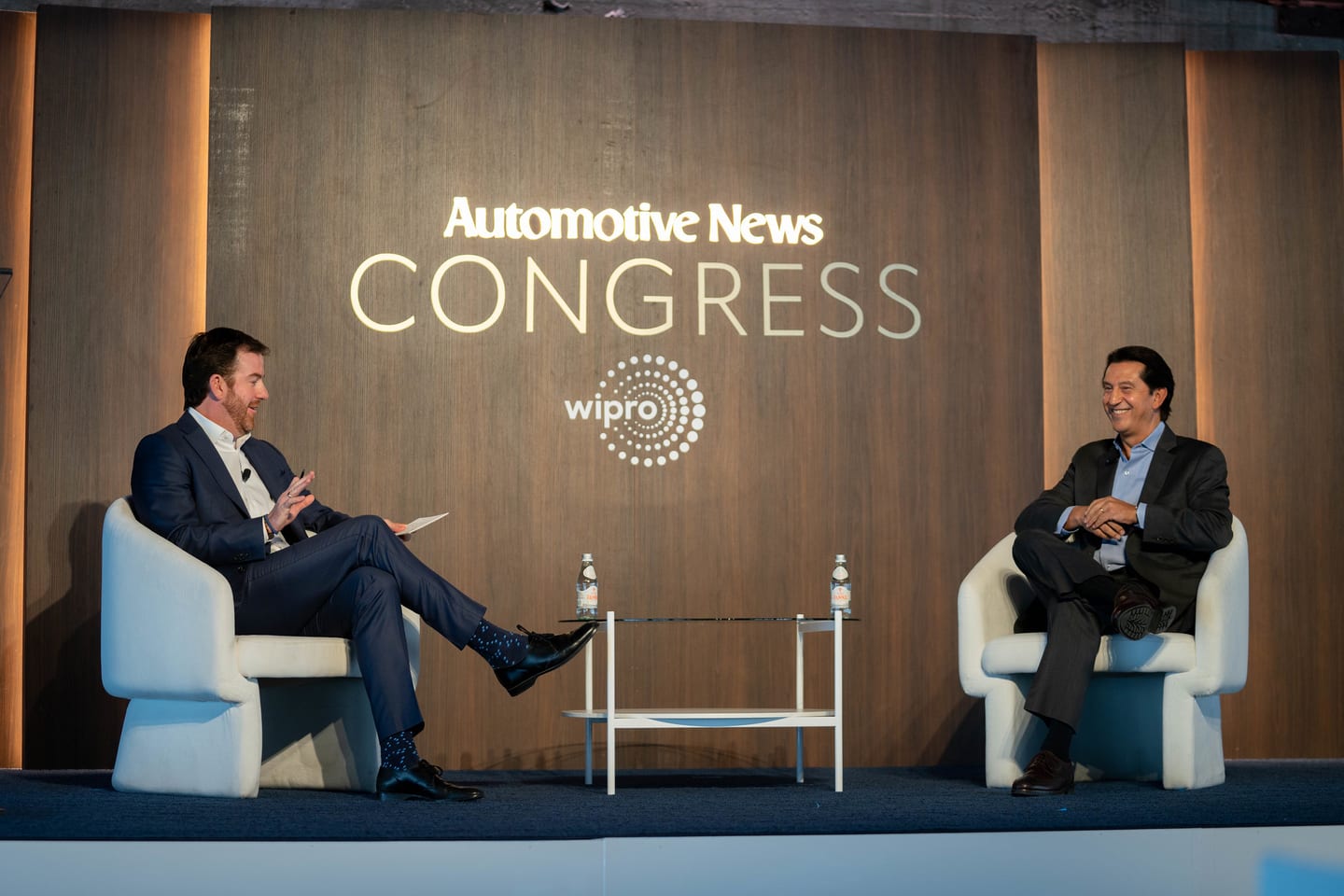 Two speakers in conversation on stage under the Congress branding at the Automotive News Congress: Los Angeles, City Market Social House