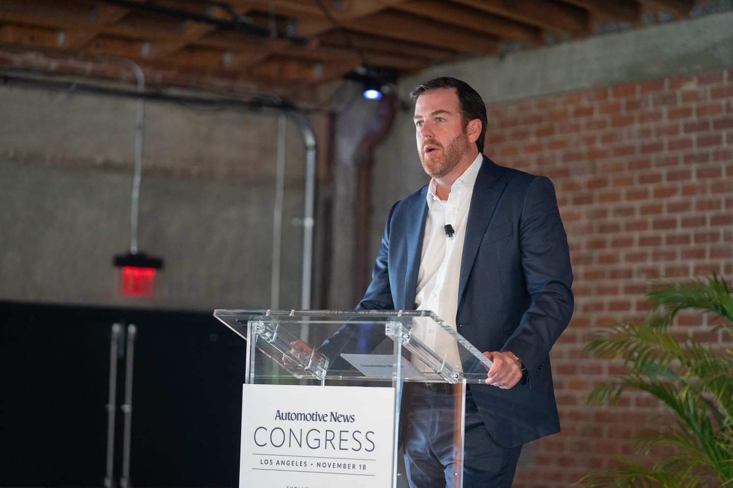 A speaker presenting from the Automotive News Congress lectern at the Automotive News Congress: Los Angeles, City Market Social House