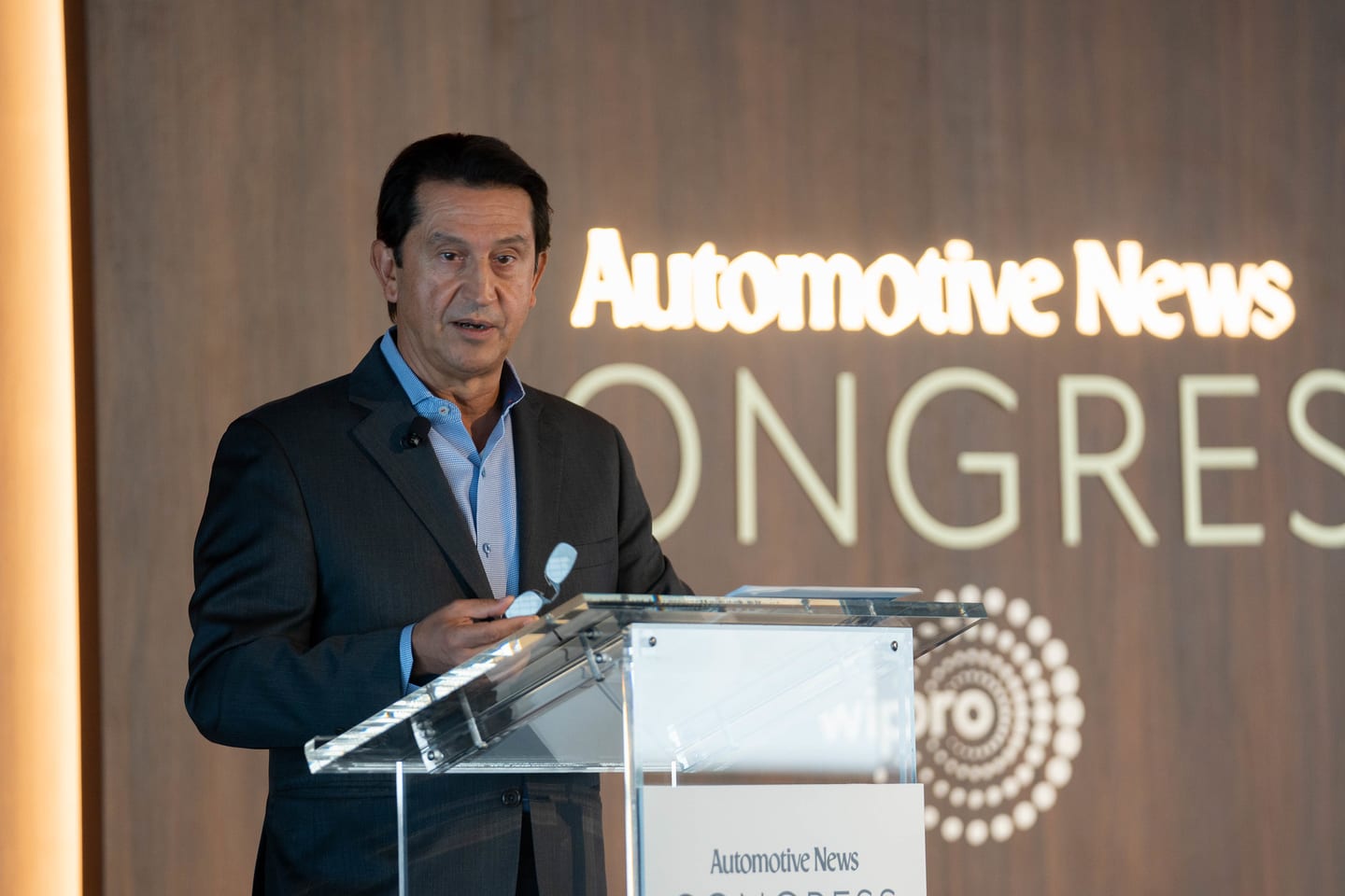 A close frame of a speaker presenting at the Automotive News lectern at the Automotive News Congress: Los Angeles, City Market Social House