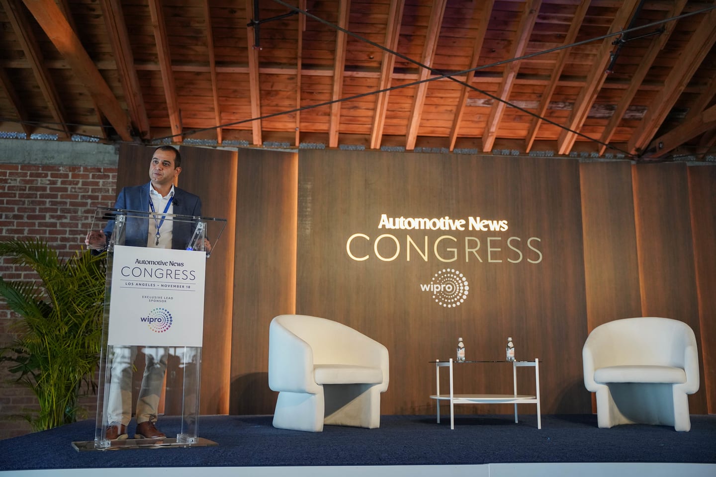 The lectern and empty lounge chairs on the Congress stage between sessions at the Automotive News Congress: Los Angeles, City Market Social House