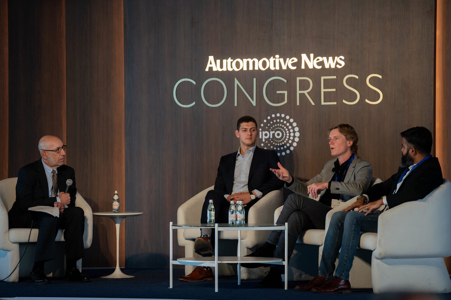Four panellists on stage under the large illuminated Automotive News Congress wall at the Automotive News Congress: Los Angeles, City Market Social House