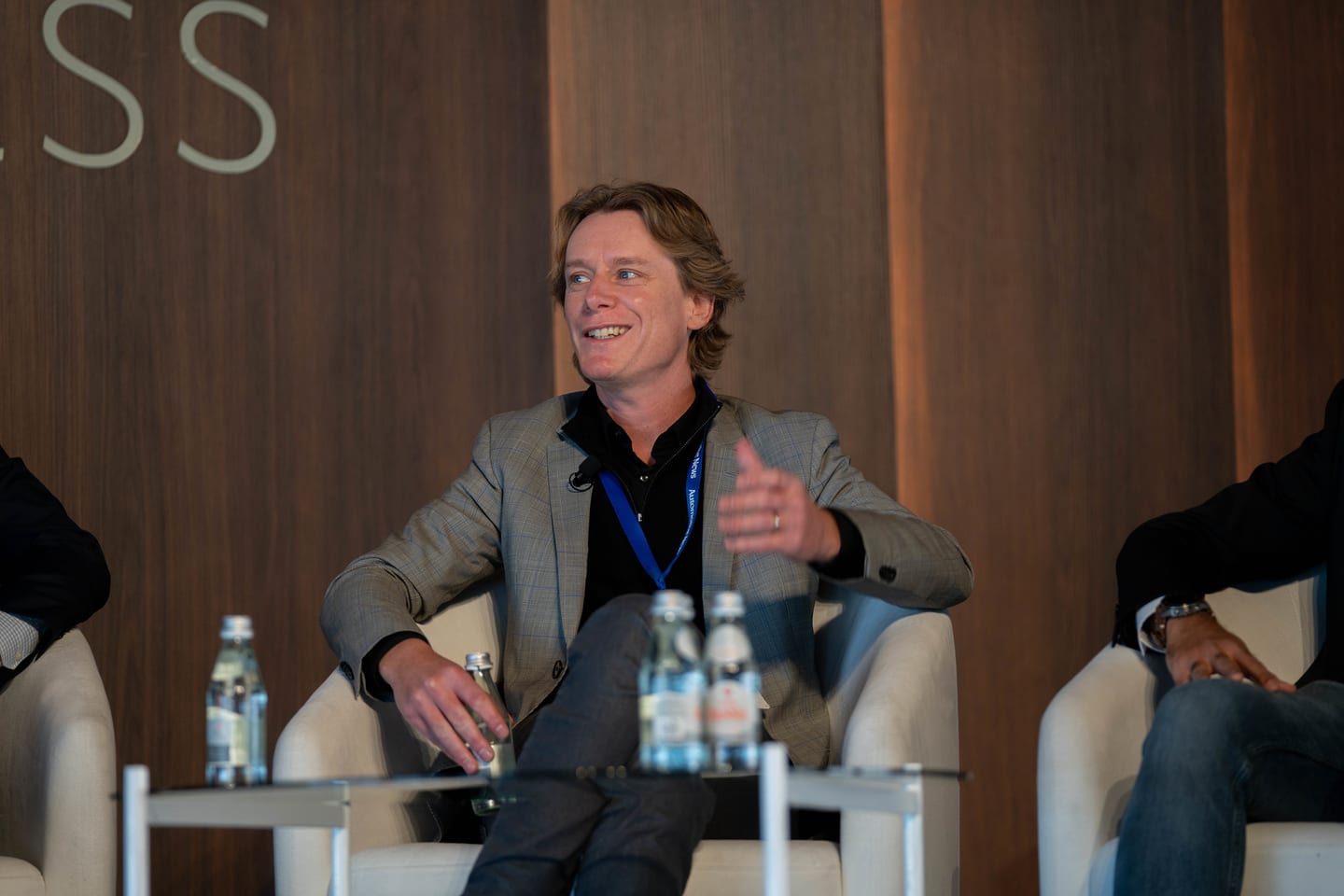 A seated panellist smiling during a stage conversation at the Automotive News Congress: Los Angeles, City Market Social House