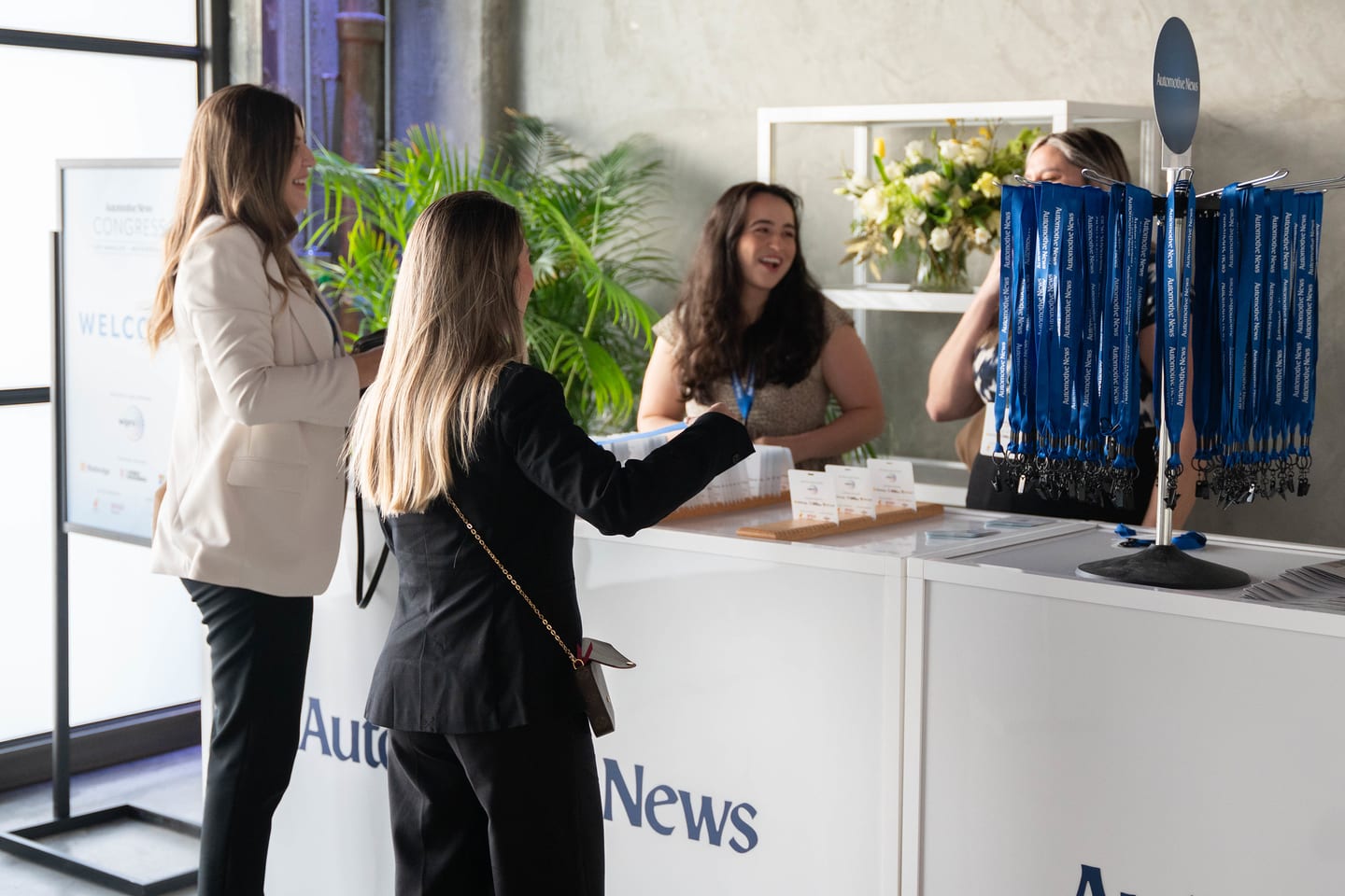 Event staff greeting arriving attendees at the Automotive News welcome desk at the Automotive News Congress: Los Angeles, City Market Social House