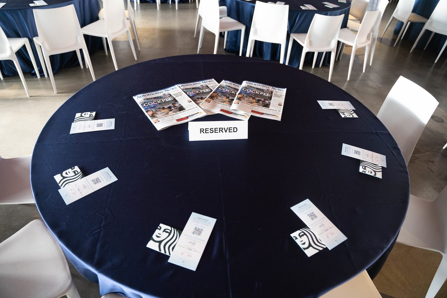 A reserved table laid with event programs before the program began at the Automotive News Congress: Los Angeles, City Market Social House