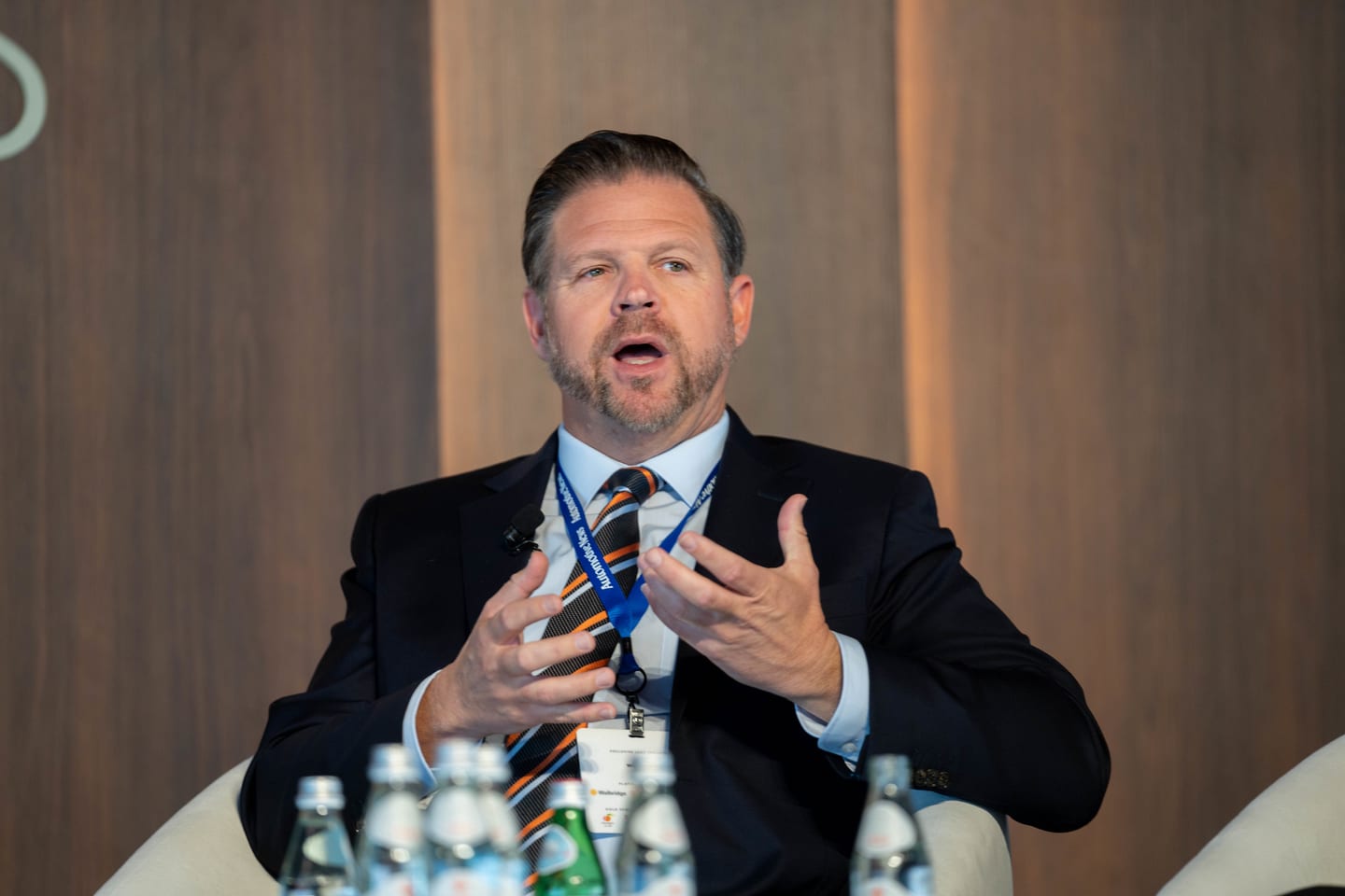 A close frame of a speaker mid-sentence during a stage session at the Automotive News Congress: Los Angeles, City Market Social House