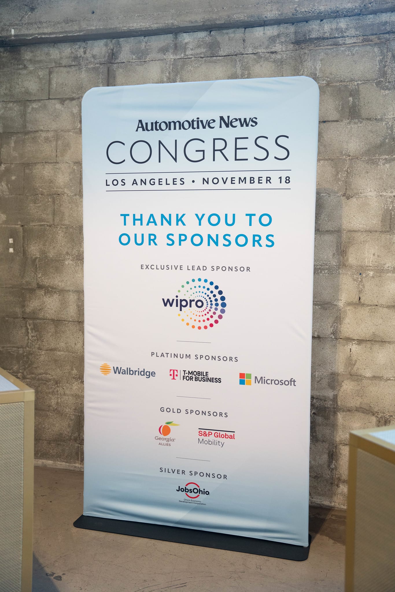 A pull-up banner reading Automotive News Congress Los Angeles November 18, thank you to our sponsors at the Automotive News Congress: Los Angeles, City Market Social House