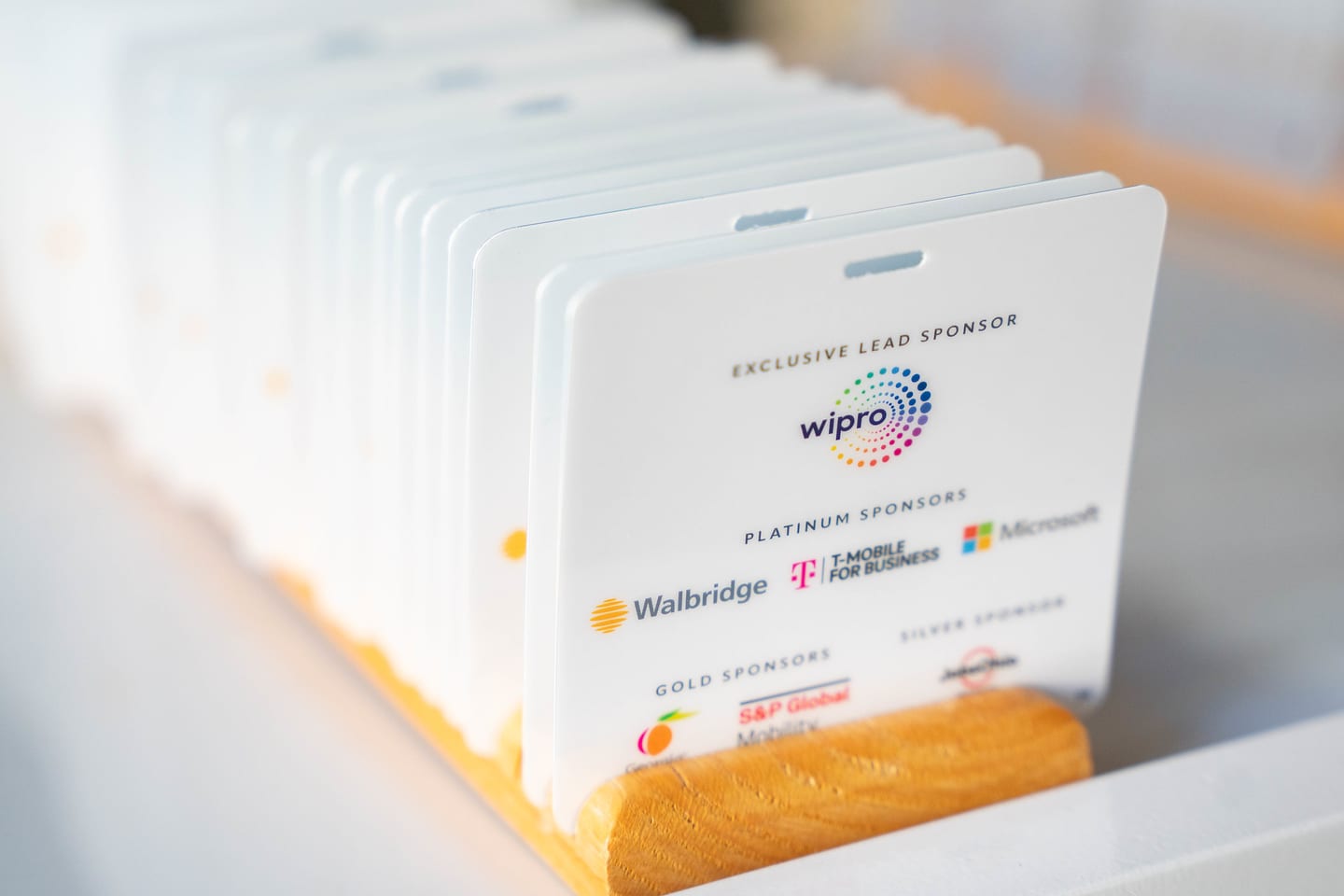 A stack of printed cards listing the Congress lead, platinum, gold and silver sponsors at the Automotive News Congress: Los Angeles, City Market Social House