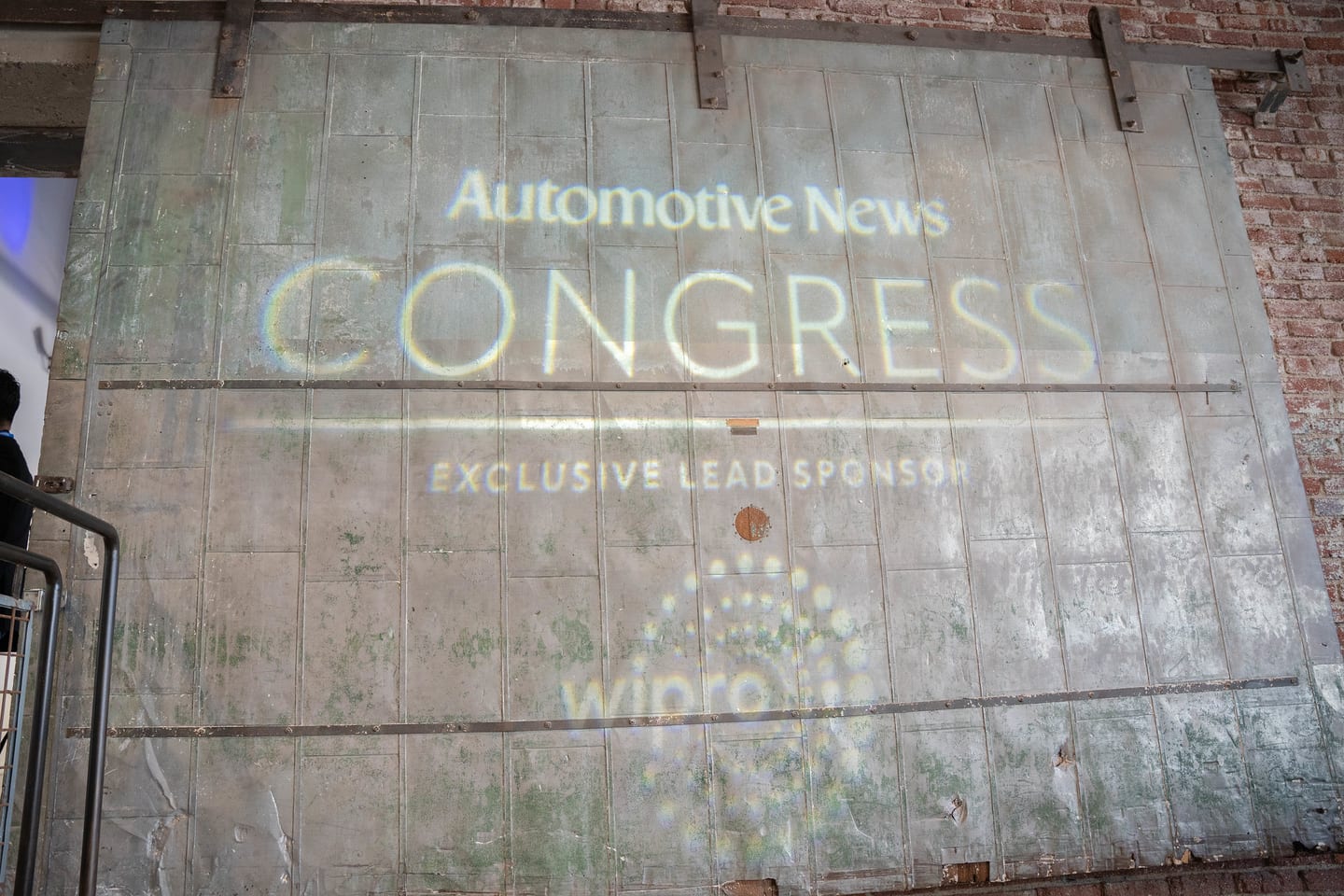 The Automotive News Congress exclusive lead sponsor Wipro logo projected large on the venue wall at the Automotive News Congress: Los Angeles, City Market Social House