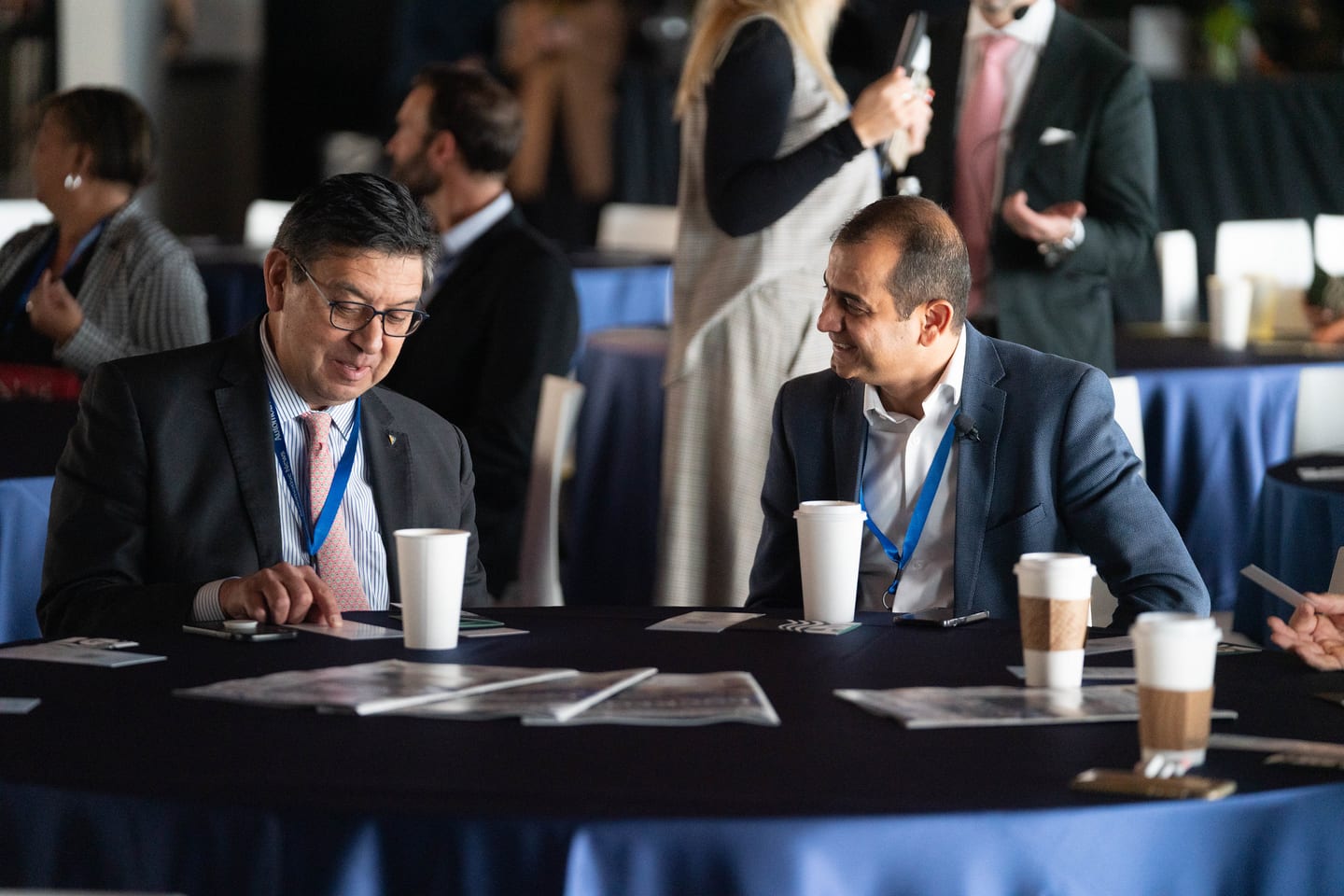 Two attendees in conversation at a round table during a break at the Automotive News Congress: Los Angeles, City Market Social House