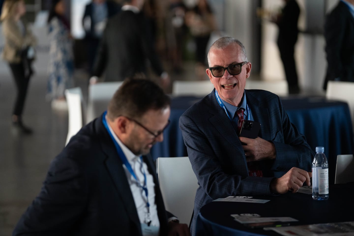 Two attendees seated and laughing during a break at the Automotive News Congress: Los Angeles, City Market Social House