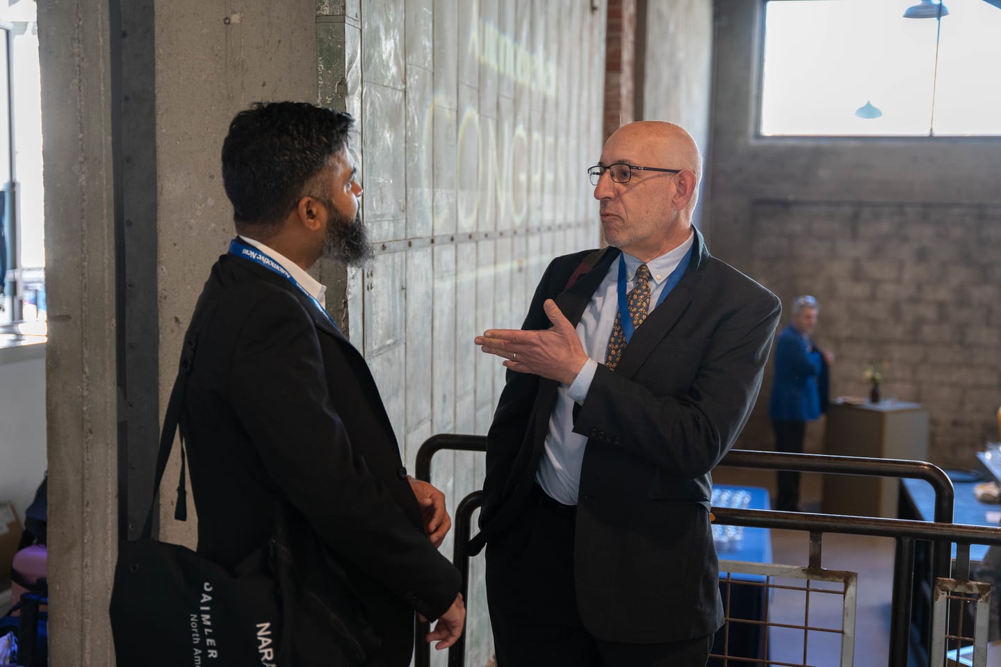 Two attendees talking during the networking portion of the morning at the Automotive News Congress: Los Angeles, City Market Social House