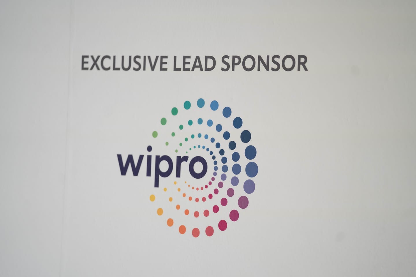 A screen reading exclusive lead sponsor above the Wipro logo at the Automotive News Congress: Los Angeles, City Market Social House