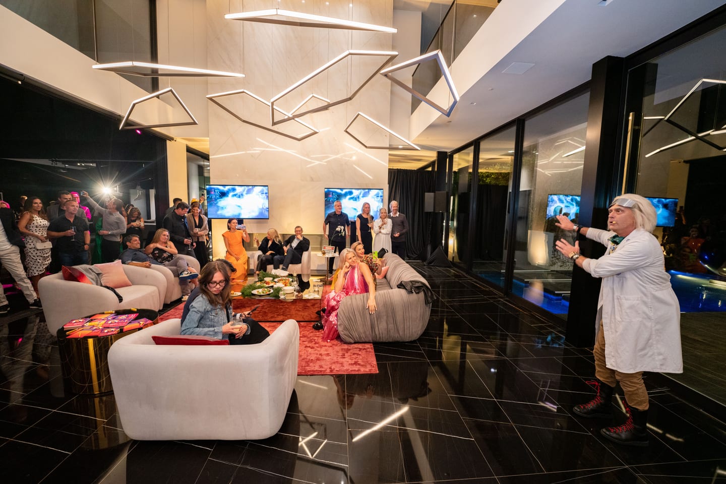 Guests in a modern lounge with geometric lighting at a private birthday party in Los Angeles