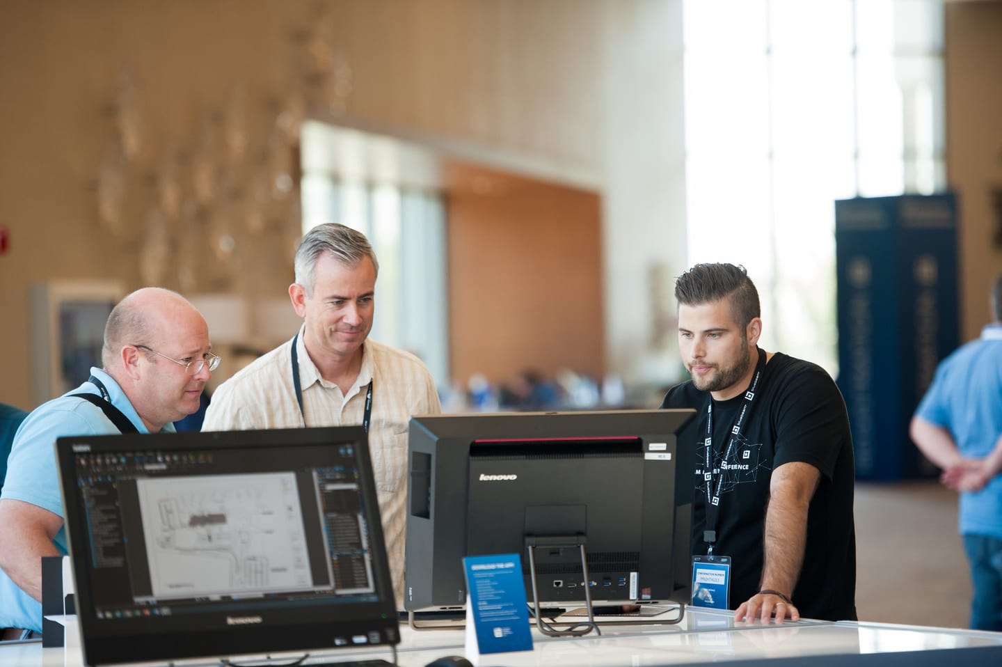 Attendees gathered around software demo stations at a Bluebeam event in San Diego