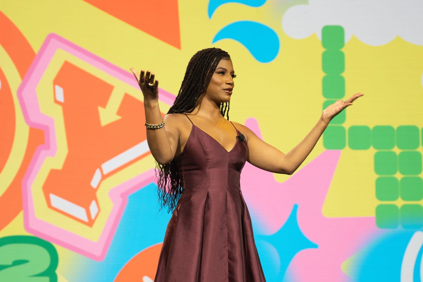 Guest in an evening gown at a colorful Los Angeles event backdrop