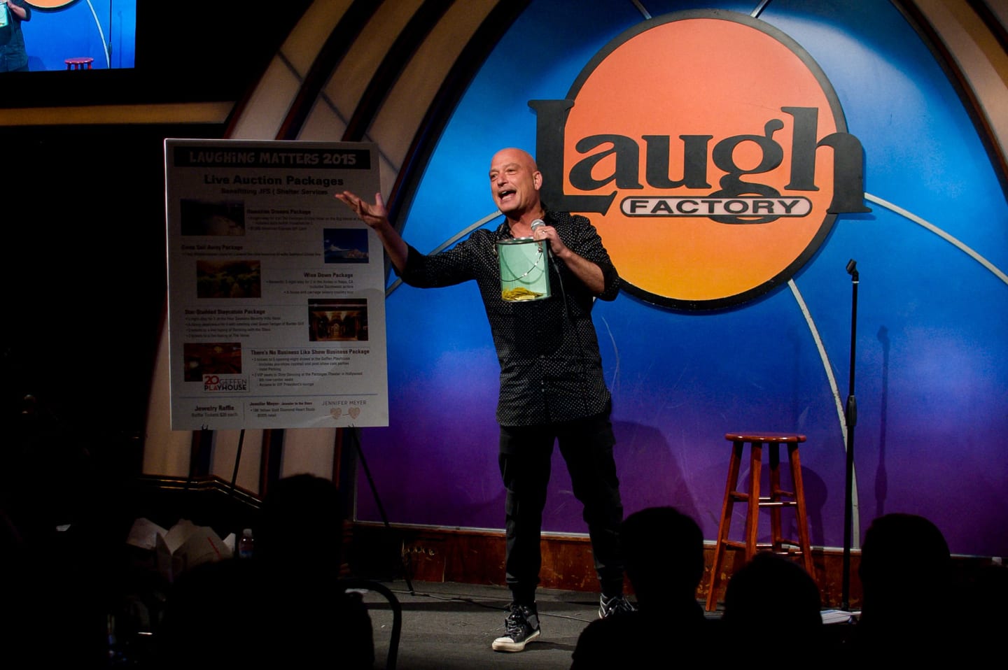 Comedian on stage at a comedy showcase