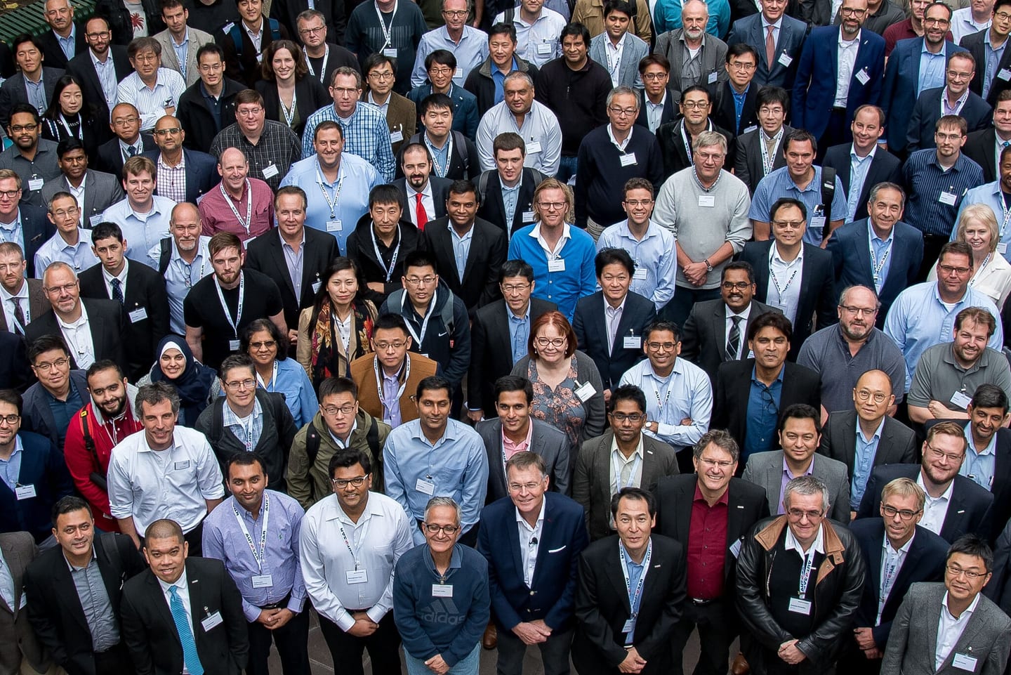 A large full-company group photo outside the Anaheim Convention Center