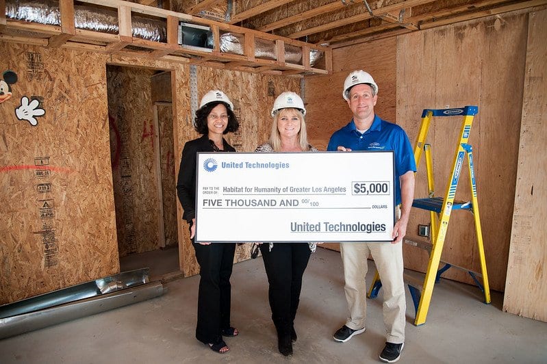 Team in hard hats presenting an oversized United Technologies check to Habitat for Humanity of Greater Los Angeles