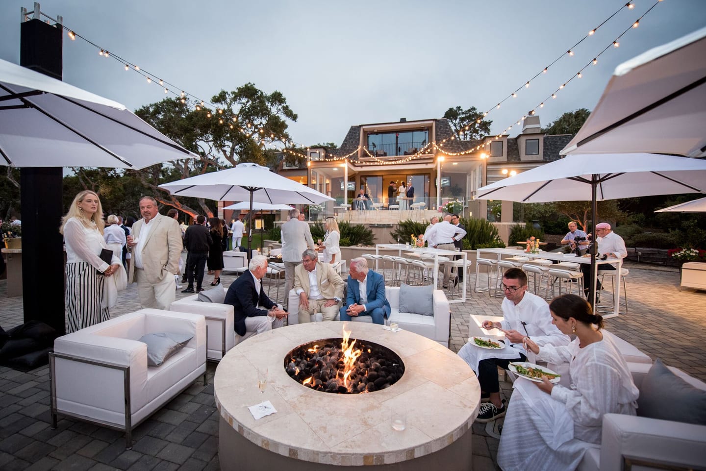 Evening lounge around a firepit at a hillside estate event