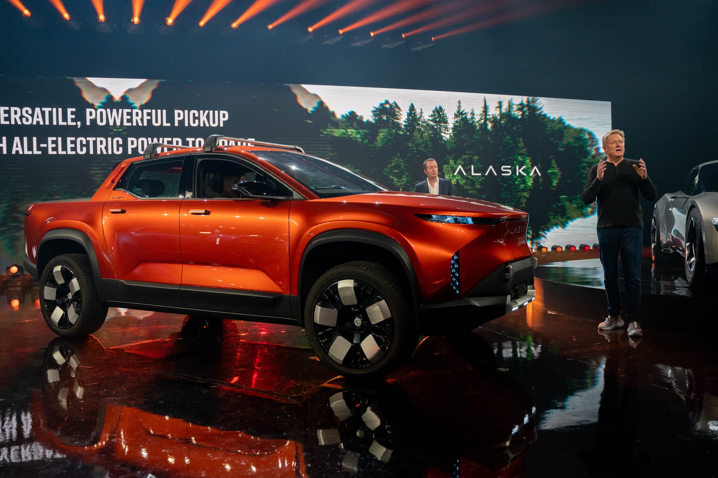 The Fisker Alaska pickup on stage, the screen reading Versatile, powerful pickup