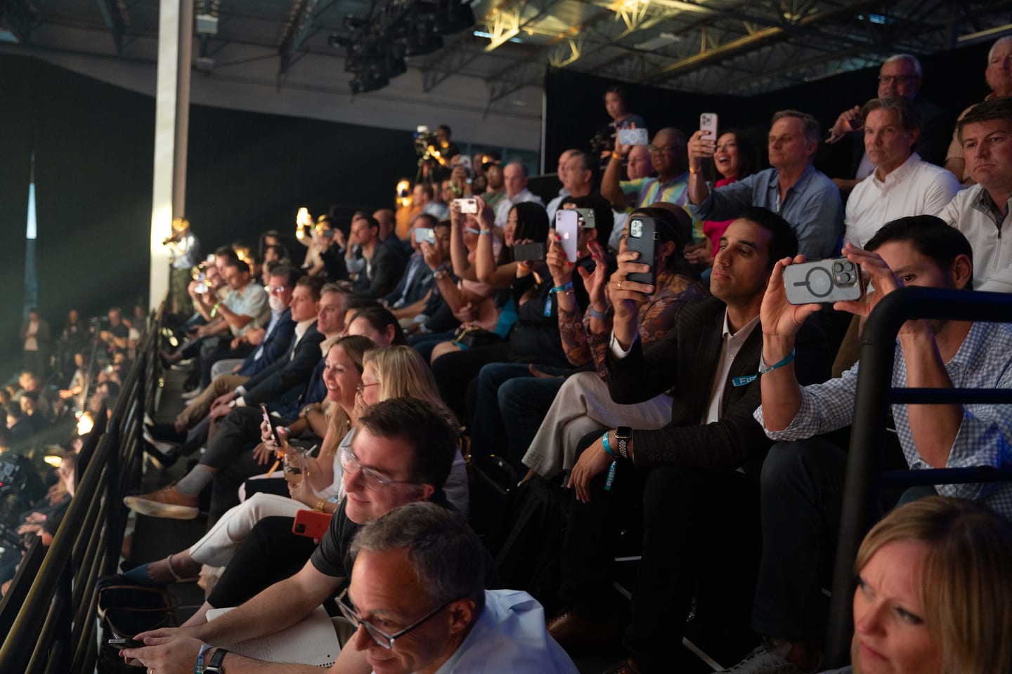 Audience members filming the stage on their phones