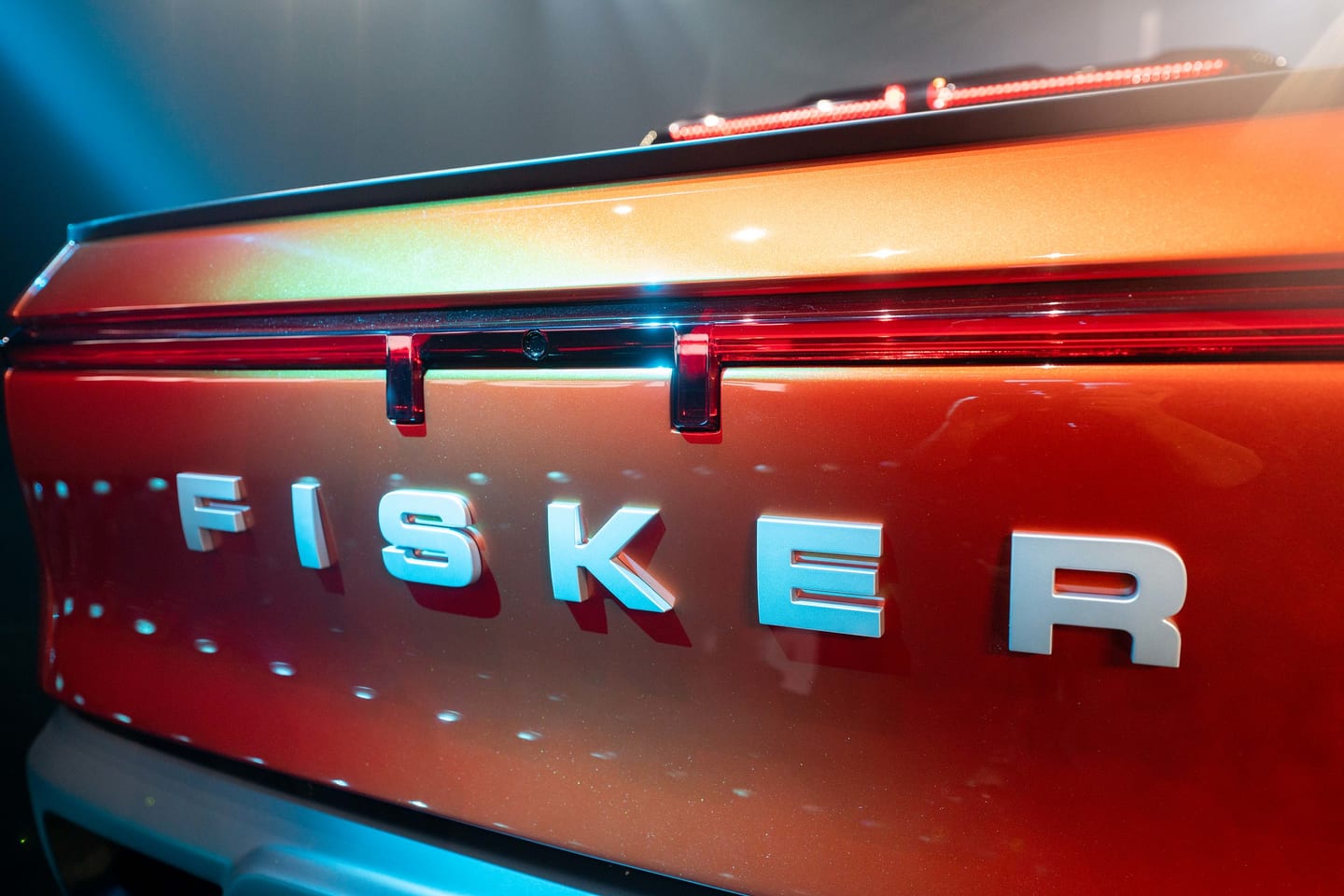 The FISKER lettering across an orange tailgate