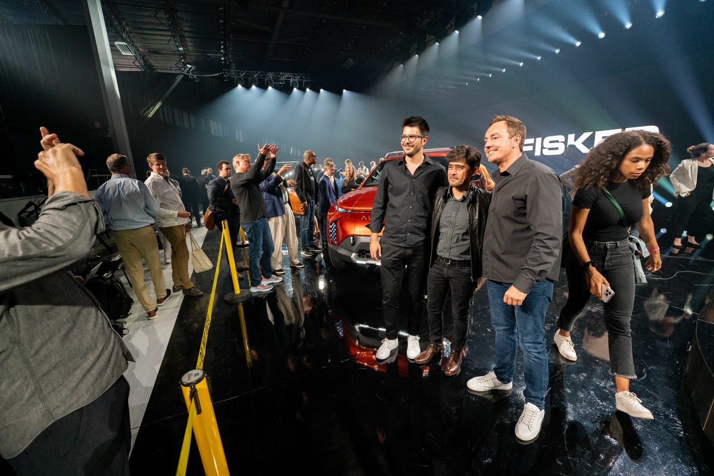 A group photographed together on the show floor