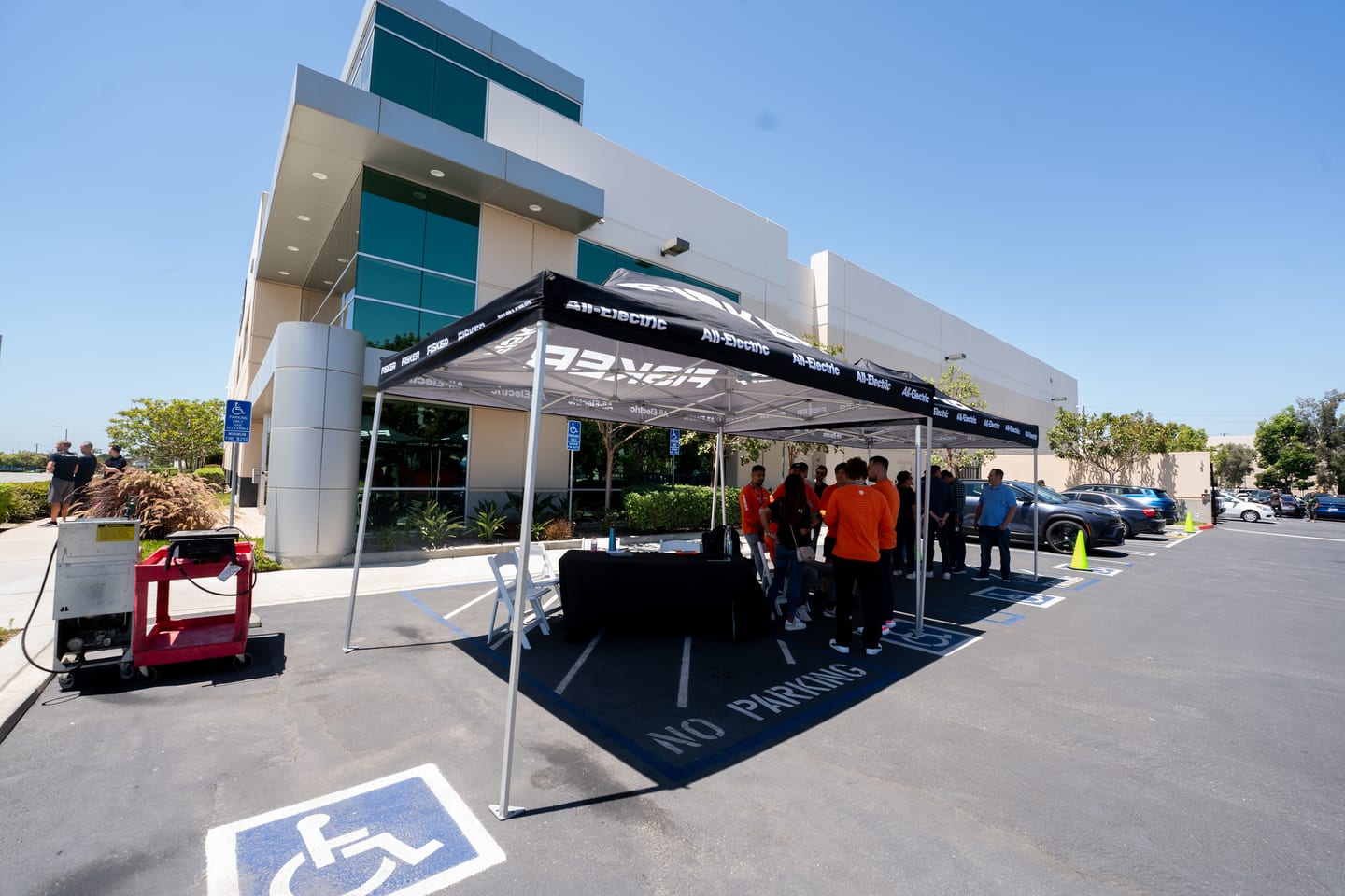 A branded tent and staff set up outside the building before the event