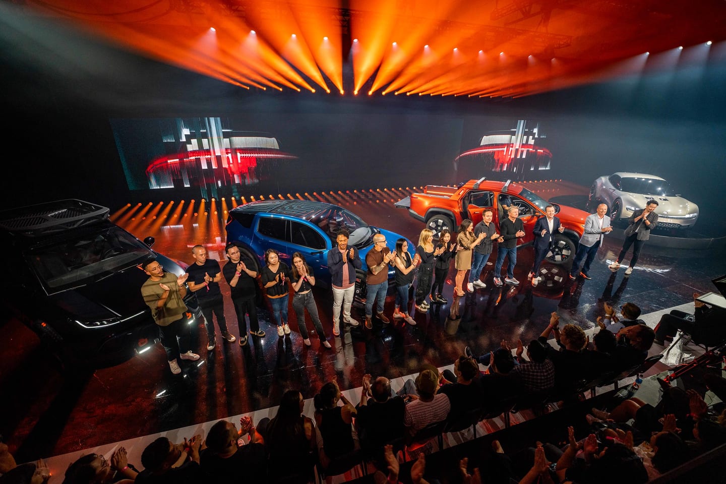 Overhead view of guests crowding around the full Fisker vehicle lineup