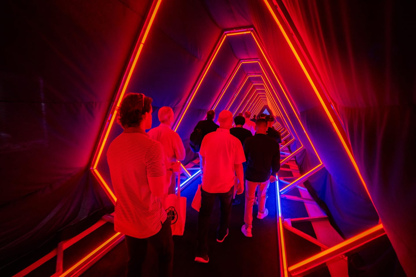 Guests gathered inside the neon tunnel activation
