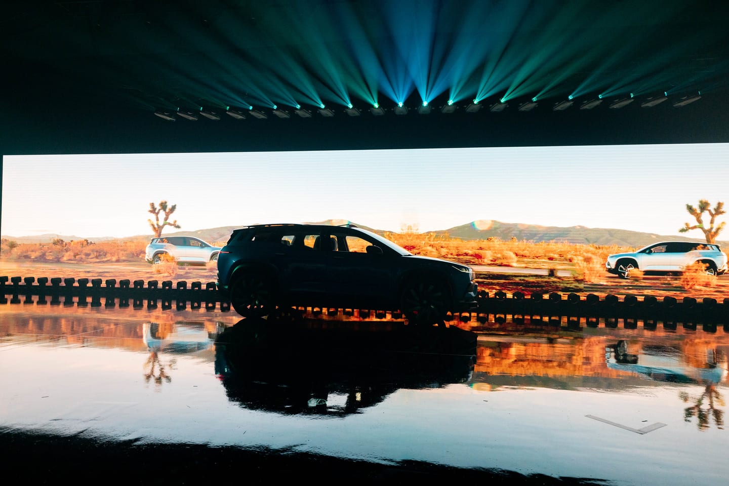 A Fisker Ocean on stage against a desert landscape screen