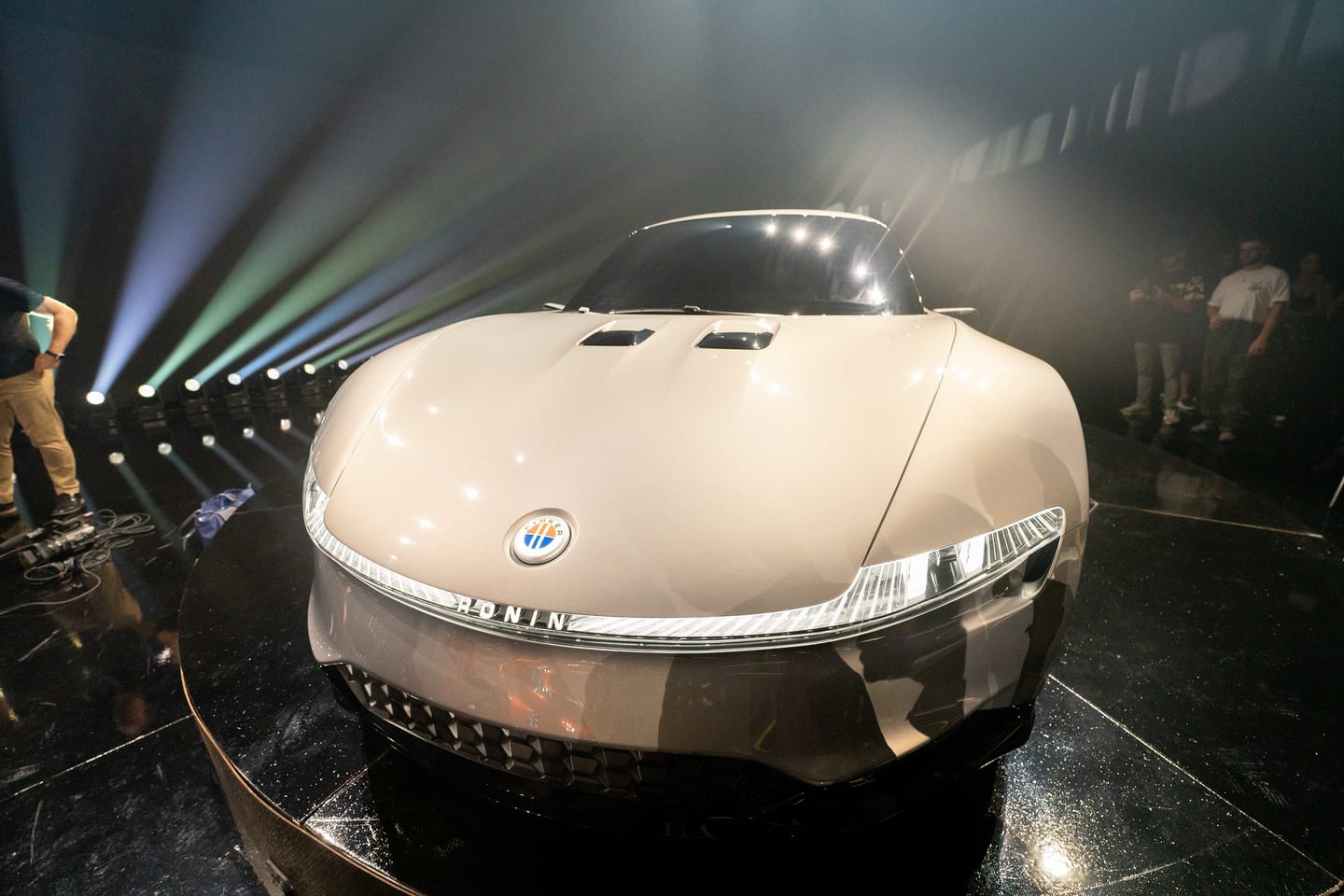 The Fisker Ronin concept car lit on a stage turntable