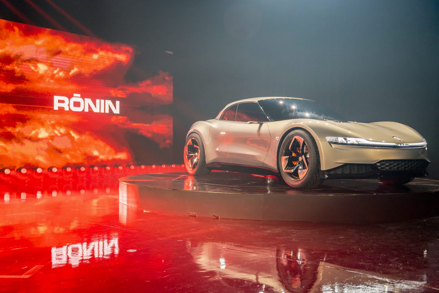 The Fisker Ronin on the turntable against a red sky screen