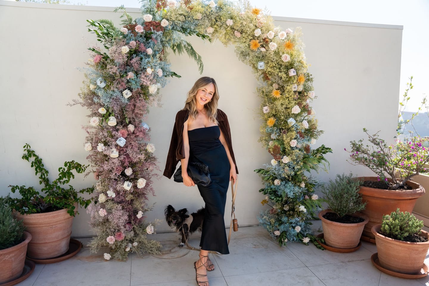 Guest by a floral arch at an event
