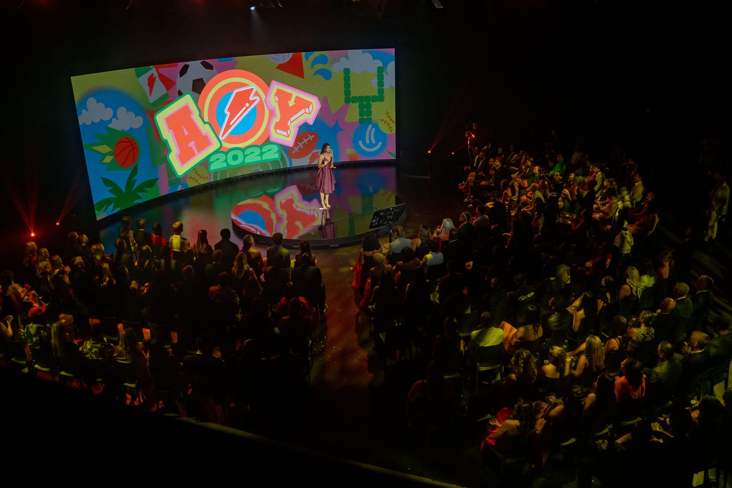 Wide view of the seated audience facing the AOY 2022 stage screen
