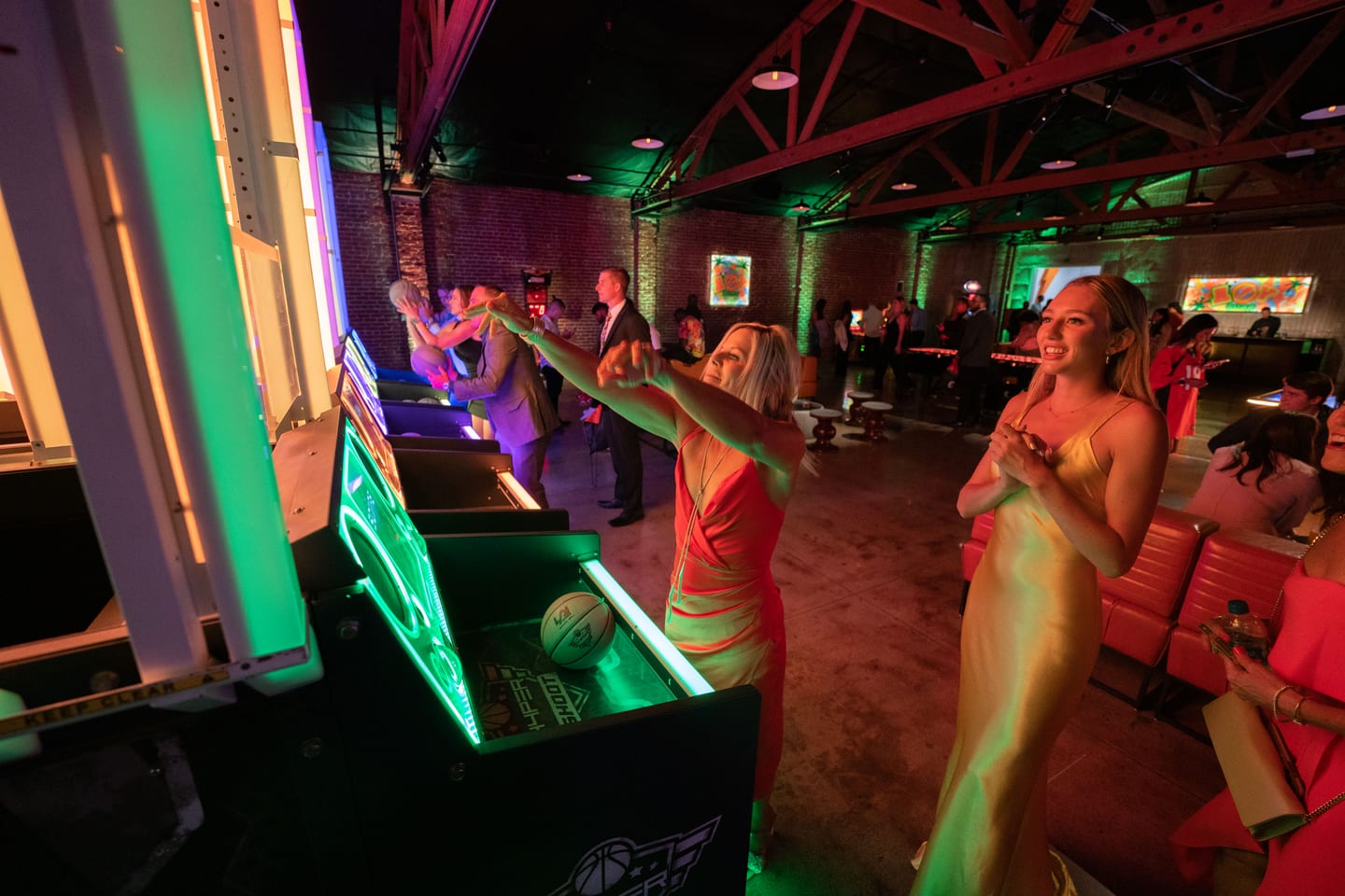 Guests playing games under neon light at the Athlete of the Year party