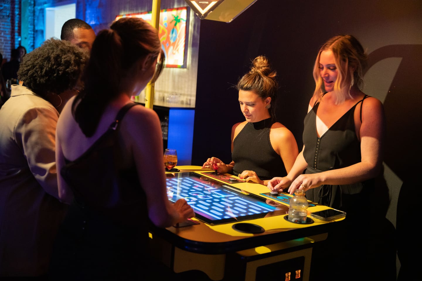 Guests playing a lit tabletop game at the Athlete of the Year party