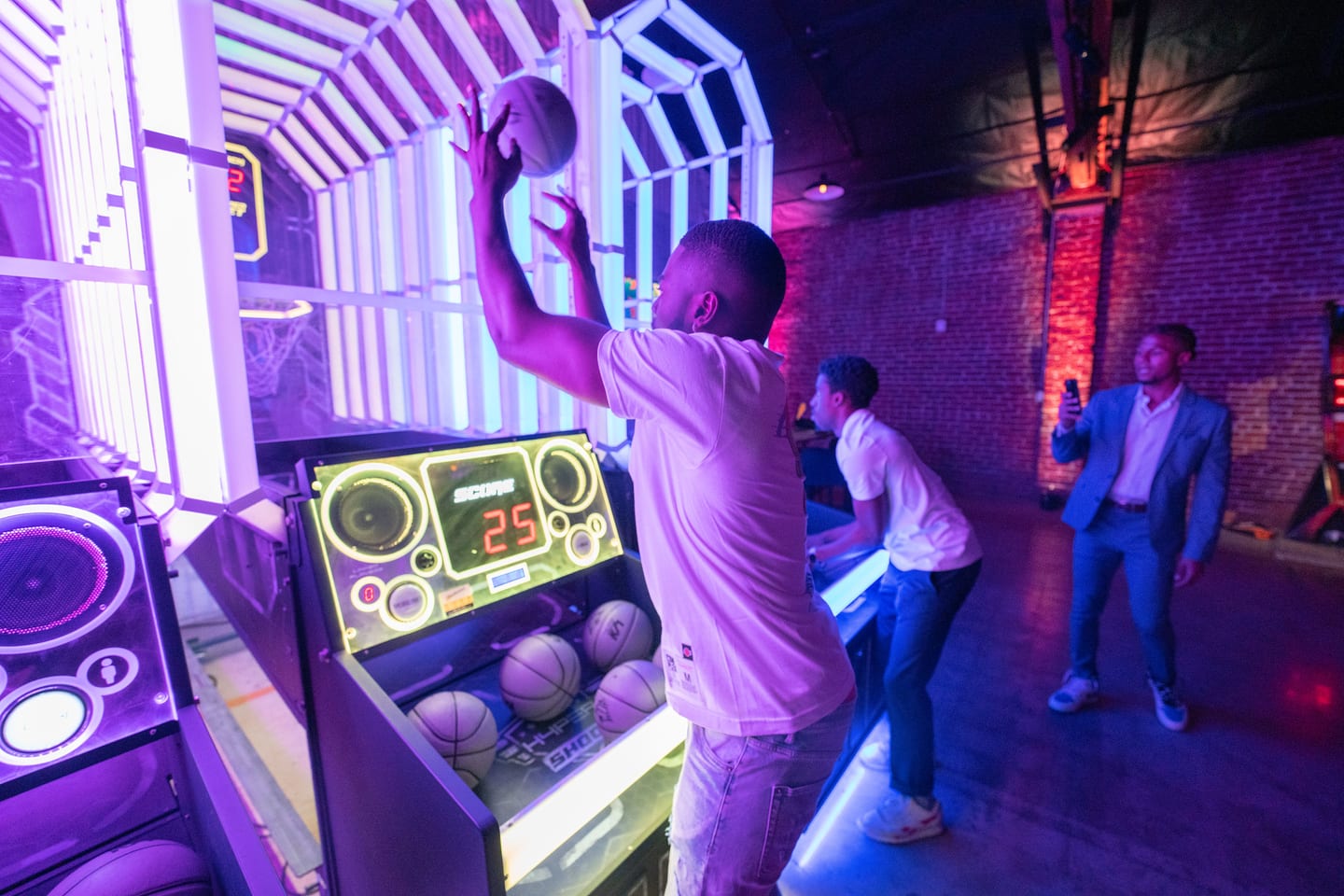 A guest shooting on a basketball arcade game