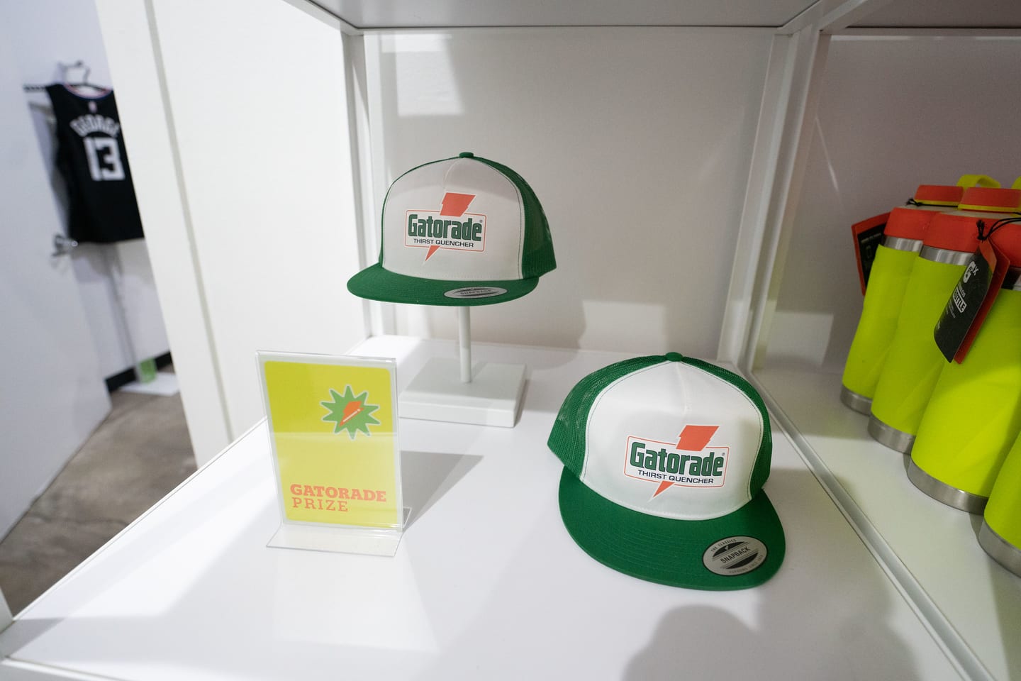 A Gatorade cap and cup displayed on a white plinth