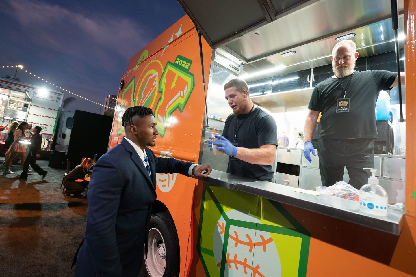 Staff serving from a Gatorade-branded food truck at the party
