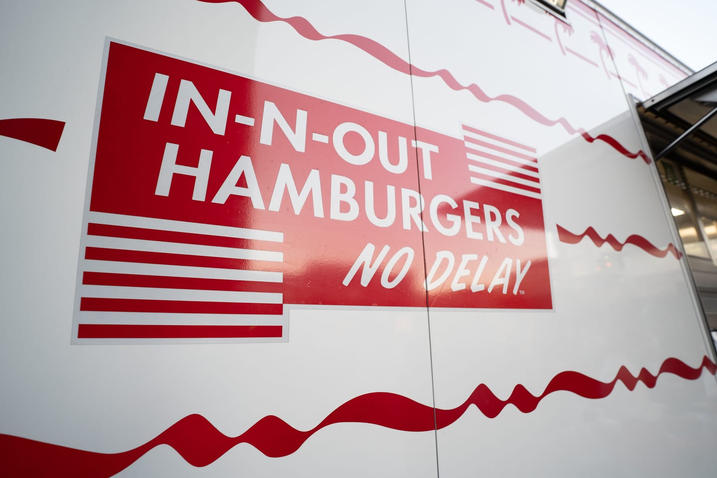 An In-N-Out Hamburgers sign mounted at the event food activation