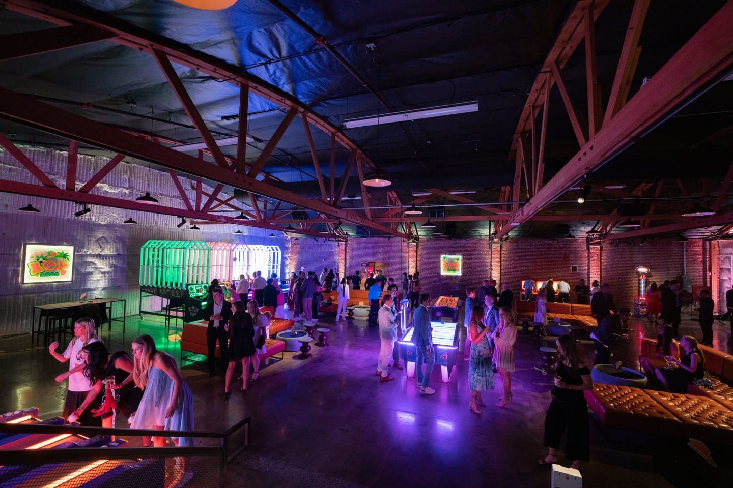 Wide view of the venue arcade floor in purple and blue light