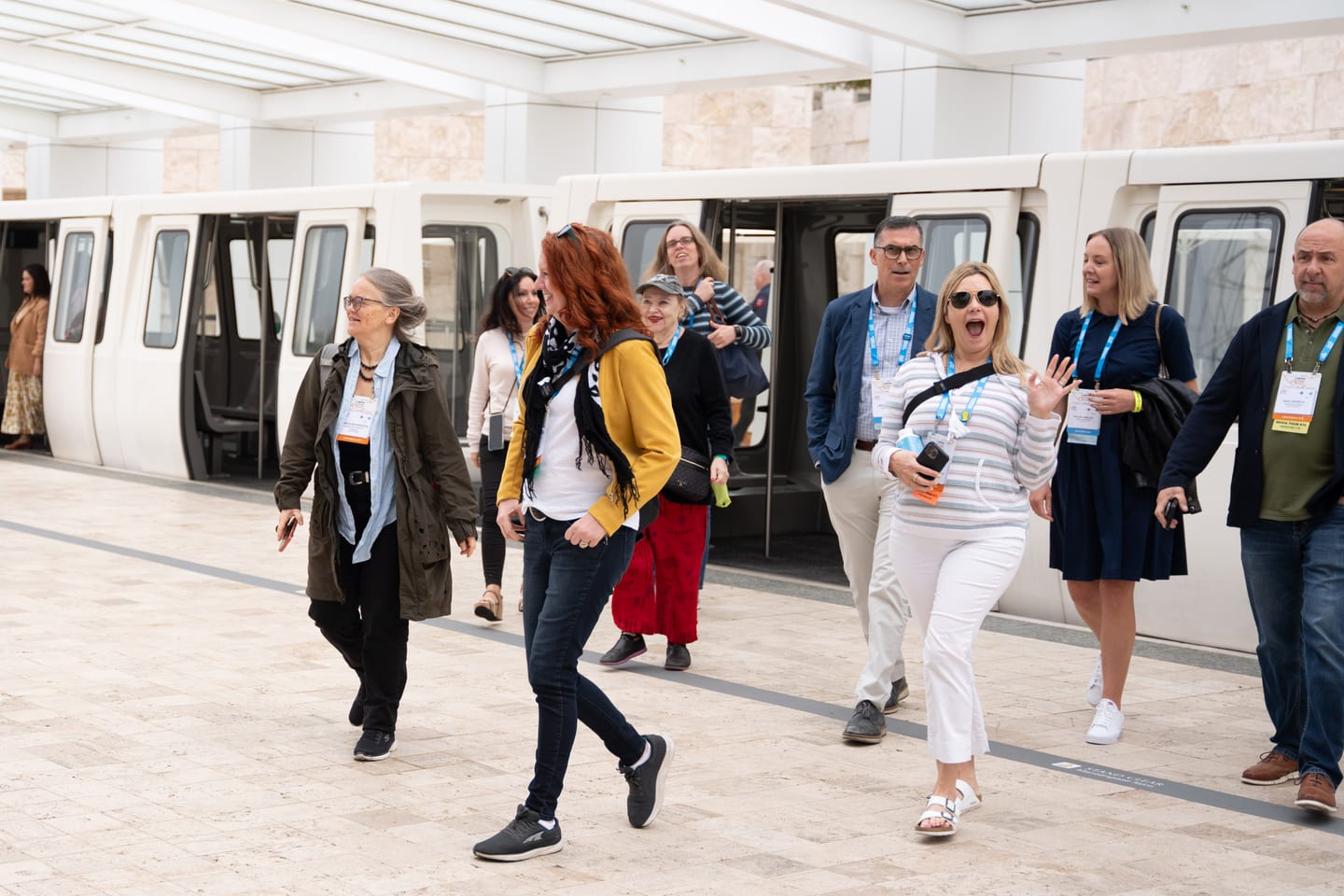 Laughing IPW delegates stepping off the tram at the Getty Center for an offsite press event