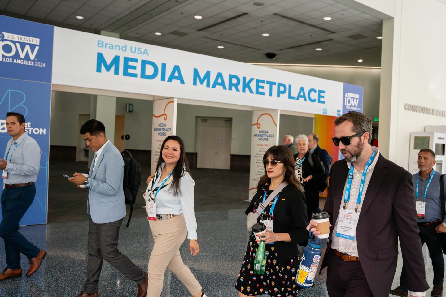 Delegates walking past the Brand USA Media Marketplace entrance banner at IPW