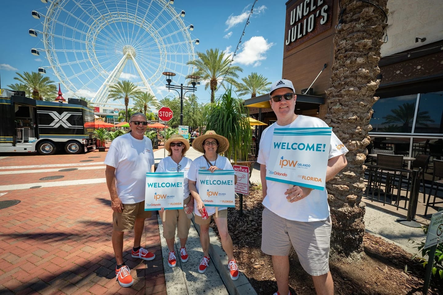 Volunteers holding welcome signs at IPW, the U.S. travel trade show in Orlando